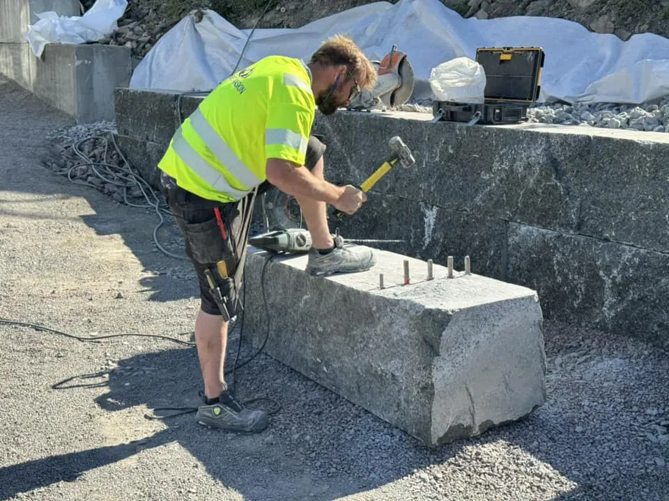 Fagarbeider kløyver granittblokk